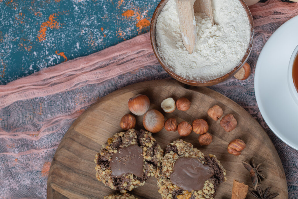 crocante chocolate cookies with nuts on a wooden board
